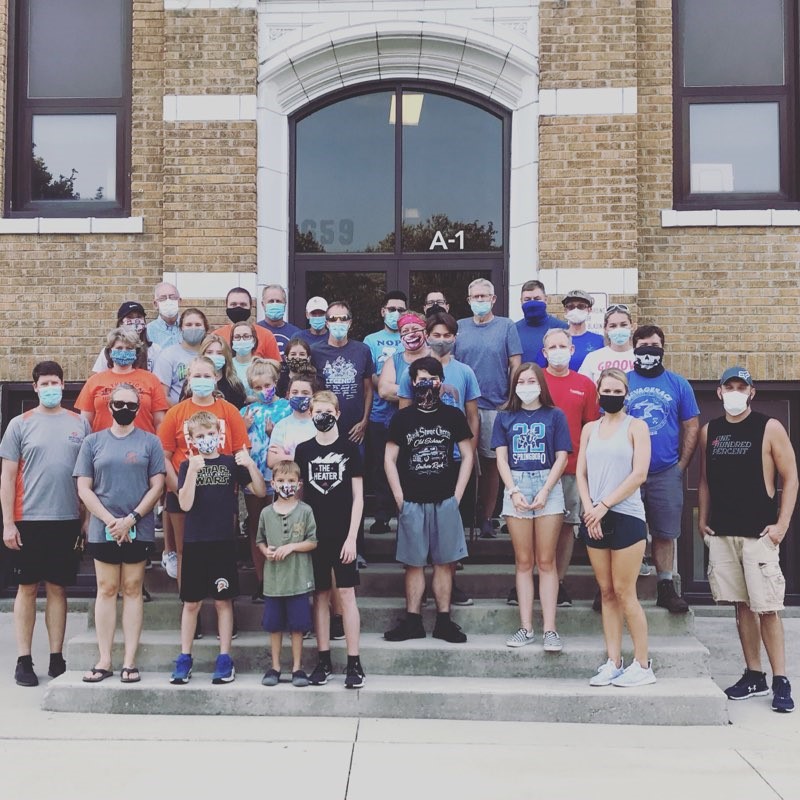 group shot of people on stairs wearing masks